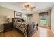 A beautifully furnished bedroom with hardwood floors, complemented by windows and a ceiling fan at 3592 Midvale Cv, Tucker, GA 30084
