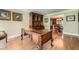 Office featuring hardwood floors, ornate desk, hutch and views into the dining room at 3592 Midvale Cv, Tucker, GA 30084