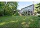 Back exterior of house showing deck and landscaped lawn at 5143 Meadowlake Ln, Dunwoody, GA 30338
