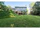 Back exterior view of home with lush backyard and deck at 5143 Meadowlake Ln, Dunwoody, GA 30338