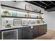 Basement bar area with modern cabinetry, marble countertop, and wine fridge at 5143 Meadowlake Ln, Dunwoody, GA 30338