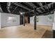 Spacious basement with fireplace, exposed ceiling, and light wood floors at 5143 Meadowlake Ln, Dunwoody, GA 30338