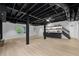Finished basement features exposed ceiling, modern bar, and light floors at 5143 Meadowlake Ln, Dunwoody, GA 30338