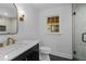 Bathroom featuring modern vanity, glass shower, and updated fixtures at 5143 Meadowlake Ln, Dunwoody, GA 30338