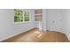 Bedroom with built-in shelving, storage, and hardwood flooring at 5143 Meadowlake Ln, Dunwoody, GA 30338