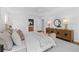 A lovely bedroom boasts a large bed, hardwood floors, a sitting bench, and stylish wooden cabinet at 5143 Meadowlake Ln, Dunwoody, GA 30338