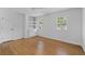 Bright bedroom with built-in shelves and hardwood floors at 5143 Meadowlake Ln, Dunwoody, GA 30338