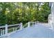 Outdoor deck surrounded by lush greenery, providing a tranquil outdoor retreat at 5143 Meadowlake Ln, Dunwoody, GA 30338