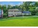 Traditional two-story home with manicured lawn and mature trees creating a beautiful curb appeal at 5143 Meadowlake Ln, Dunwoody, GA 30338