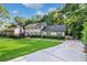 Traditional two-story home with a well-manicured lawn and mature landscaping at 5143 Meadowlake Ln, Dunwoody, GA 30338