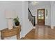 Warm foyer featuring hardwood floors, a wooden front door, and elegant lighting at 5143 Meadowlake Ln, Dunwoody, GA 30338