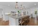 Bright, modern kitchen with a large center island, pendant lighting and stainless steel appliances at 5143 Meadowlake Ln, Dunwoody, GA 30338