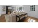 Bright living room with hardwood floors, a fireplace, and built-in shelving at 5143 Meadowlake Ln, Dunwoody, GA 30338
