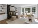 Inviting living room with a black brick fireplace, built-in bookshelves, and natural light at 5143 Meadowlake Ln, Dunwoody, GA 30338