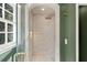 Bathroom featuring tiled shower with glass enclosure, arched doorway, and a rainfall shower head at 5143 Meadowlake Ln, Dunwoody, GA 30338