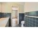 Bathroom with unique blue tiling, updated fixtures, and neutral paint at 5401 Smoke Rise Dr, Smoke Rise, GA 30087