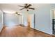 Spacious bedroom with hardwood floors, ceiling fan, and bathroom door at 5401 Smoke Rise Dr, Smoke Rise, GA 30087