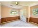 Comfortable bedroom featuring a ceiling fan, natural light, and closet space at 5401 Smoke Rise Dr, Smoke Rise, GA 30087