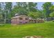 Two-story home featuring brick and siding, an American flag, and a green lawn at 5401 Smoke Rise Dr, Smoke Rise, GA 30087