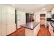 Spacious kitchen with white cabinetry, large island, and hardwood floors at 5401 Smoke Rise Dr, Smoke Rise, GA 30087