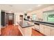Spacious kitchen with white cabinetry, a center island, and modern appliances at 5401 Smoke Rise Dr, Smoke Rise, GA 30087