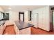 Bright kitchen featuring hardwood floors, black countertop island, and white cabinets at 5401 Smoke Rise Dr, Smoke Rise, GA 30087