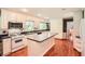 Bright kitchen with white cabinets, a center island, and a gas cooktop stove at 5401 Smoke Rise Dr, Smoke Rise, GA 30087