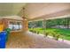 Stone patio with a ceiling fan, brick walls, and a view of the backyard at 5401 Smoke Rise Dr, Smoke Rise, GA 30087