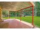 Open patio with metal framing, a grassy yard, and a storage shed in the background at 5401 Smoke Rise Dr, Smoke Rise, GA 30087