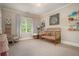 Adorable Bedroom with natural light, a comfortable rocking chair, and a golden crib at 1126 Francis Ne St, Atlanta, GA 30319