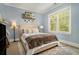 Comfortable bedroom featuring a large window with natural light and a decorative shelf with artwork at 1126 Francis Ne St, Atlanta, GA 30319