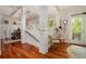 Bright entryway with hardwood floors, staircase, and access to the dining room with coffered ceiling at 1126 Francis Ne St, Atlanta, GA 30319