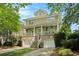 Inviting two-story home featuring a brick foundation and a charming front porch with dual ceiling fans at 1126 Francis Ne St, Atlanta, GA 30319