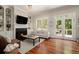 Cozy living room with fireplace, built-in shelving, and French doors to the outdoors at 1126 Francis Ne St, Atlanta, GA 30319