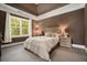 Serene bedroom featuring neutral carpet, a large window and an elegant trey ceiling at 1126 Francis Ne St, Atlanta, GA 30319