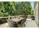 Outdoor dining set on a spacious deck surrounded by lush greenery and mature trees at 1126 Francis Ne St, Atlanta, GA 30319