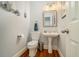 Charming powder room featuring a pedestal sink, wood floors and stylish fixtures at 1126 Francis Ne St, Atlanta, GA 30319