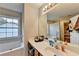 Bathroom with a double sink, a large mirror, and a tub with a large window view at 1171 Pine Acre Dr, Sugar Hill, GA 30518