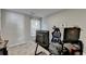 This bedroom has neutral colored walls and carpeting with a desk and office chair at 1171 Pine Acre Dr, Sugar Hill, GA 30518