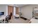 This bedroom has neutral carpeting and walls, a desk, treadmill, shelving, and an office chair at 1171 Pine Acre Dr, Sugar Hill, GA 30518