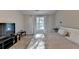 Bedroom with a bed, tv and a large window with curtains at 1171 Pine Acre Dr, Sugar Hill, GA 30518