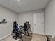 This is a bedroom with neutral walls and carpeting, a desk, and a white door at 1171 Pine Acre Dr, Sugar Hill, GA 30518