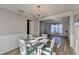 Bright dining room with decorative chandelier and open view to the cozy living area at 1171 Pine Acre Dr, Sugar Hill, GA 30518