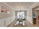 Formal dining room with wainscoting, chandelier, and wood floors, offering a sophisticated space at 1171 Pine Acre Dr, Sugar Hill, GA 30518