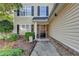 View of the home's front entrance, showing a well-kept lawn and a decorative wreath on the door at 1171 Pine Acre Dr, Sugar Hill, GA 30518