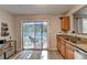 Kitchen with stainless steel sink, granite counters, and sliding glass doors to backyard patio at 1171 Pine Acre Dr, Sugar Hill, GA 30518