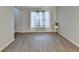 Cozy living room featuring light gray walls, wood flooring, and bright window at 1171 Pine Acre Dr, Sugar Hill, GA 30518