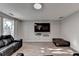 Inviting living room showcasing a flat screen TV, plush leather furniture, and wood-look flooring at 1171 Pine Acre Dr, Sugar Hill, GA 30518