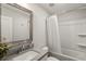 Bright bathroom featuring a shower-tub combination and stylish chrome-framed mirror at 408 Niles Ct, Marietta, GA 30060