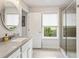 Modern bathroom boasts a vanity, updated fixtures, natural light and a glass enclosed shower at 408 Niles Ct, Marietta, GA 30060